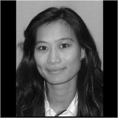 Black and white portrait of investor Mia Vo, smiling with long dark hair.