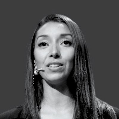 Black and white portrait of investor Mia Vo, smiling with long dark hair.